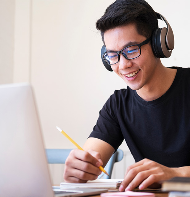 A young man smiles during an online therapy session. Online cognitive behavioral therapy (CBT) in San Francisco and Los Angeles can help with a variety of mental health issues. 