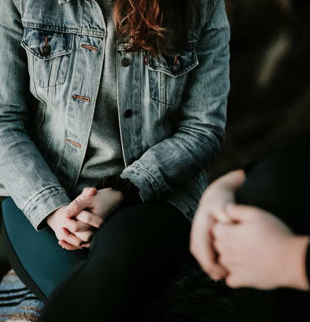 A woman sits and speaks to another person, showing how substance use therapy in San Francisco and Los Angeles can help individuals overcome substance use challenges.